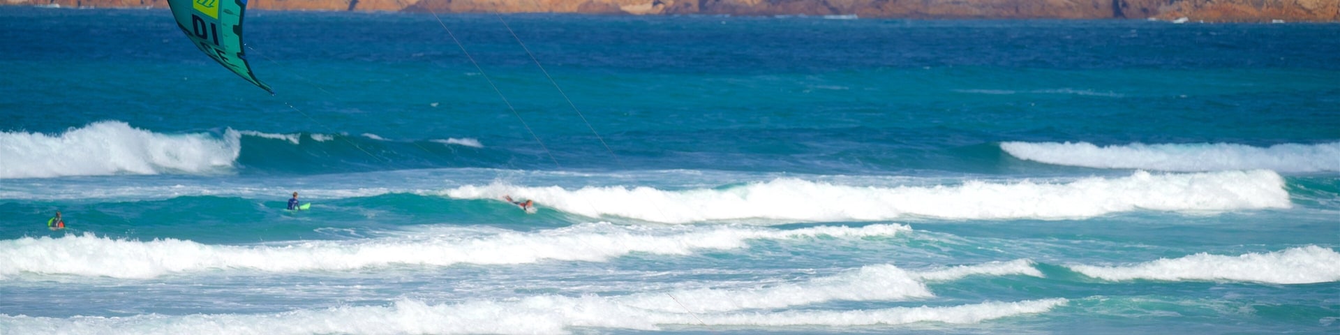 Praia do Guincho featuring general coastal views, rocky coastline and kite surfing
