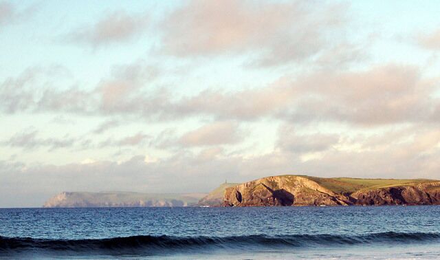 Three headlands seen from Harlyn Bay Looking north-east from the beach at Harlyn Bay. The evening sun illuminates three headlands: Pentire Point (on left, far distance); Stepper Point (centre, surmounted by tower); and Gunver Head (right).