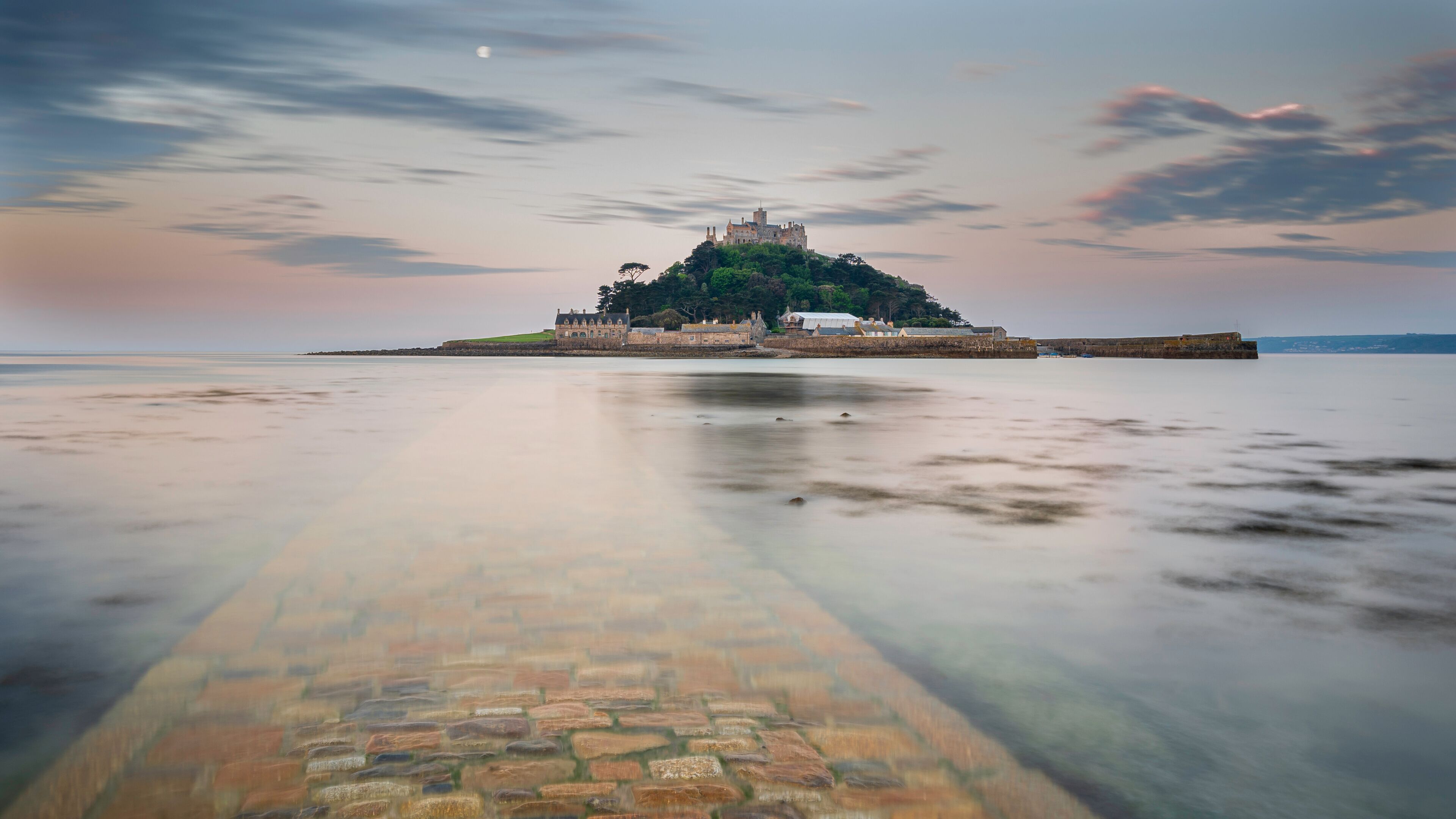 St. Michael's Mount, Cornwall, at sunrise. The causeway can be seen under the incoming tide, which is smooth and calm