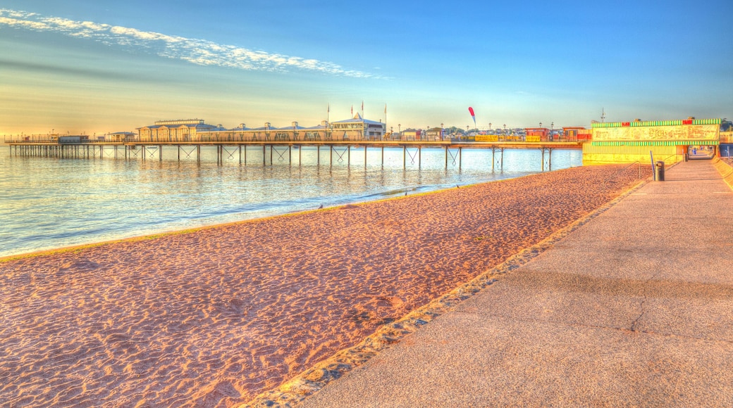 DE6GTK Paignton pier and sandy beach Torbay Devon England in HDR with blue sky, near tourist destinations of Torquay and Brixham