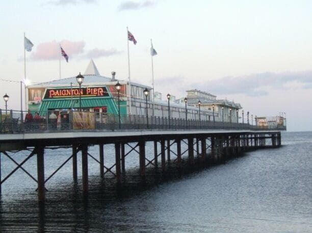 A pier with a restaurant named "Paignton Pier" and a lighthouse.