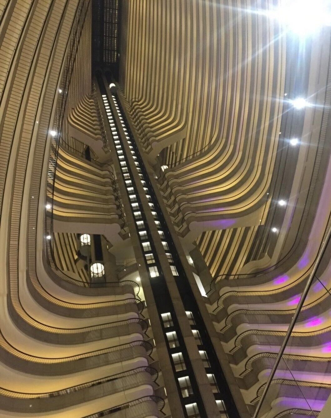 Image taken from the middle of the hotel lobby, all 47 floors of the Atlanta Marriott Marquis are shown bound by an external elevator shaft that resembles a skeletal backbone of a dinosaur. #Trovember
