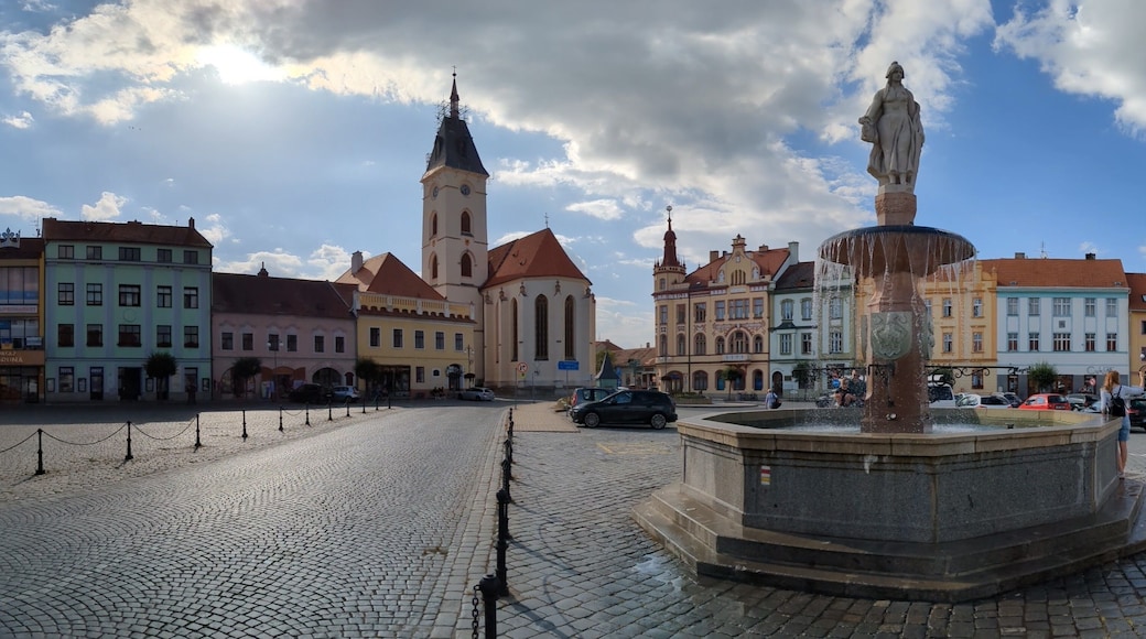 Vodnany historical old town square with fountain,column and his bohemian architecture, surrounding streets and church with tower.Bohemia,Czechia,European union