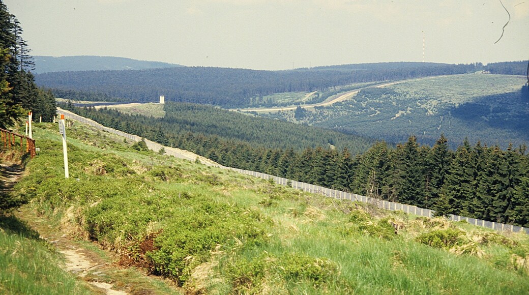 The border was a physical manifestation of Winston Churchill's metaphorical Iron Curtain that separated the Soviet and Western blocs during the Cold War. It marked the boundary between two ideological systems – Capitalism and Communism. Built by East Germany in phases from 1952 to the late 1980s, the fortifications were constructed to stop the large-scale emigration of East German citizens to the West, about 1,000 of whom are said to have died trying to cross it during its 45-year existence. It caused widespread economic and social disruption on both sides; East Germans living in the region suffered especially draconian restrictions. See Wikipedia, Inner German border.
