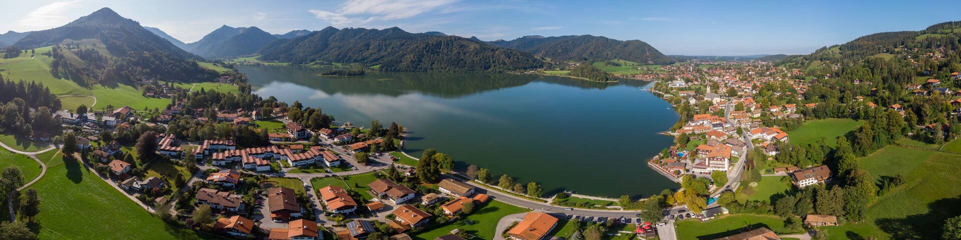 Aerial view of the city Schliersee with lake Schliersee and mountains and sky in the background