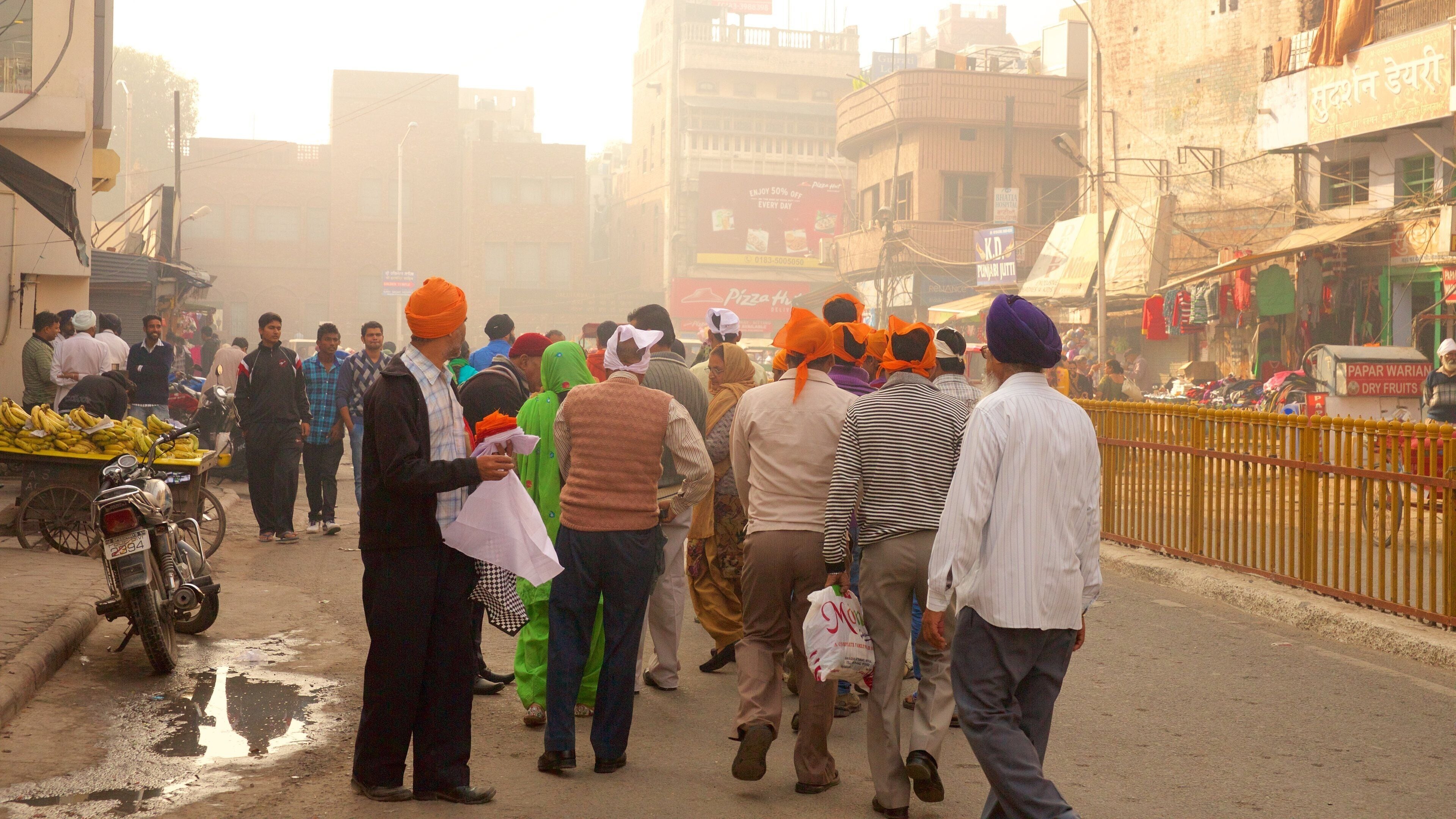 Amritsar que incluye imágenes de calles y una ciudad y también un gran grupo de personas