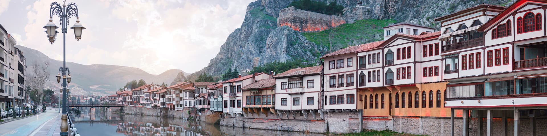 Amasya,TURKEY old riverside Turkish(ottoman) city buildings and its reflection on water,sunny summer day.Amasya is city of princes of ottoman. ottoman Princes were educated in Amasya