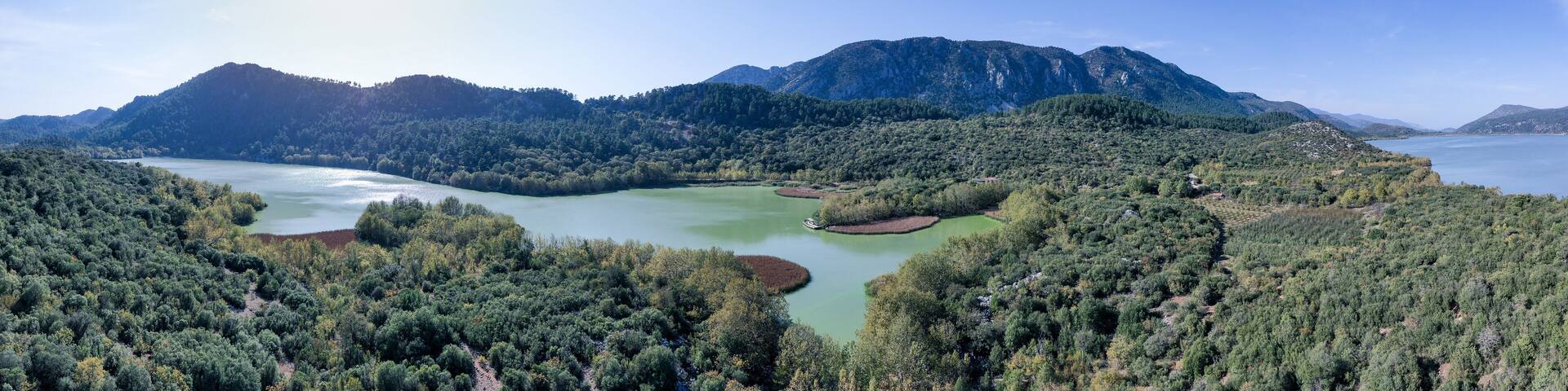 The beautiful panorama landscapes of Kovada Lake, mountains and green area from the air Isparta, Turkey Lake District.