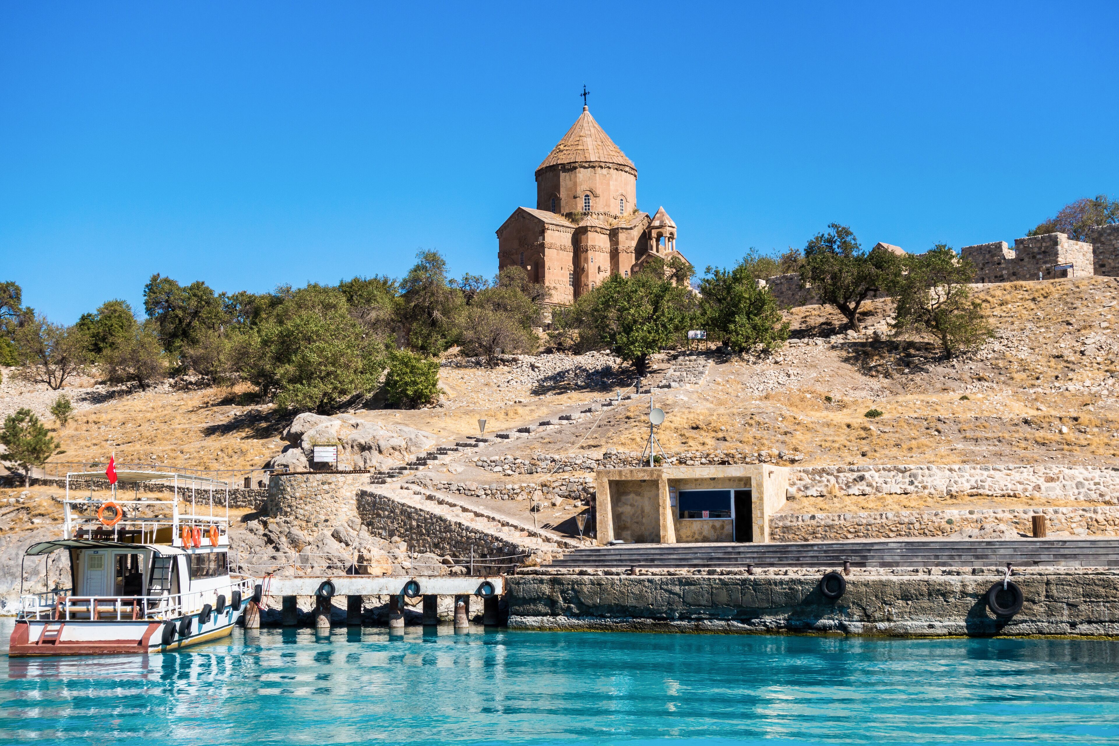 Cathedral of the Holy Cross, tourist ferryboat & wharf for boats on Akdamar island that located on Van lake, Geva≈ü, Turkey. It's popular destination in Van district for foreign & local tourists