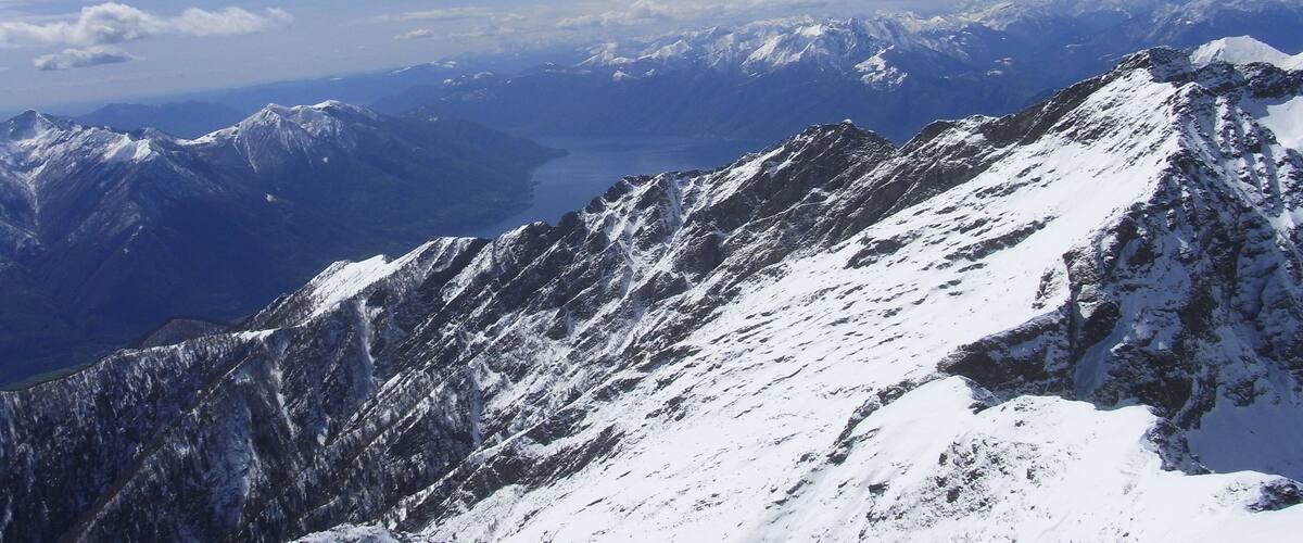 A snow-covered mountain range with a clear blue sky.