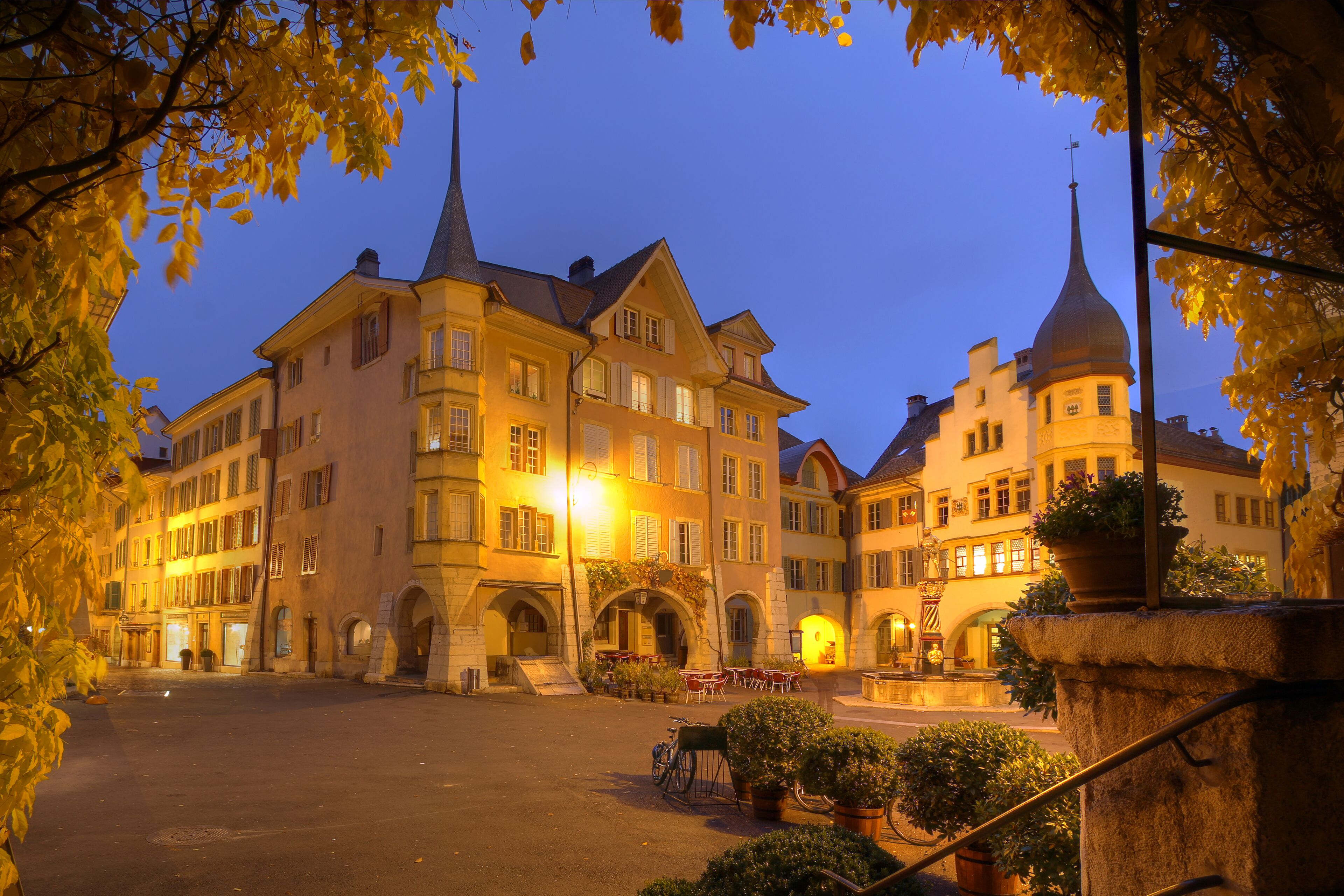 A historic building with multiple stories, arched entrances, and a prominent tower.