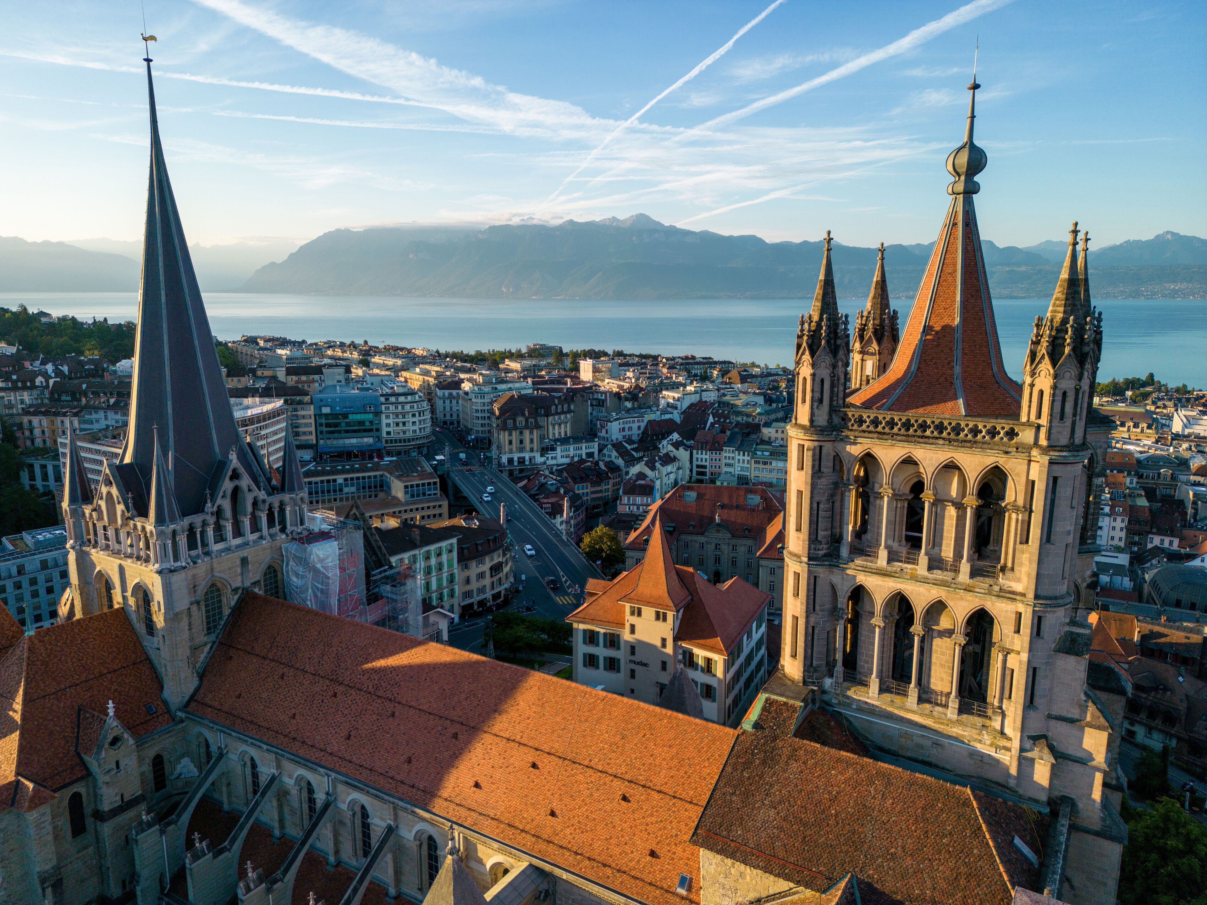 A cityscape with prominent Gothic architecture, including a church with a pointed steeple and a cathedral with multiple spires.