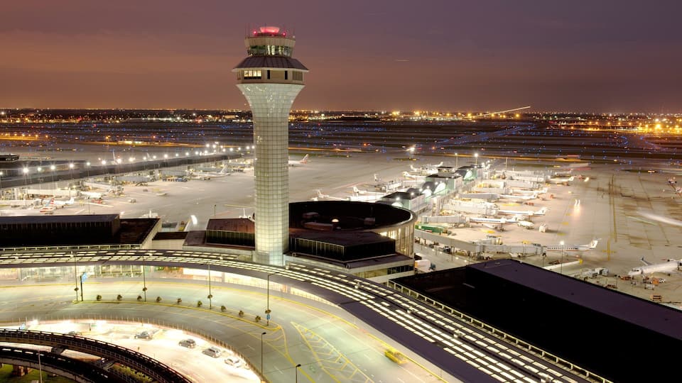 Chicago, IL which includes an airport, night scenes and landscape views