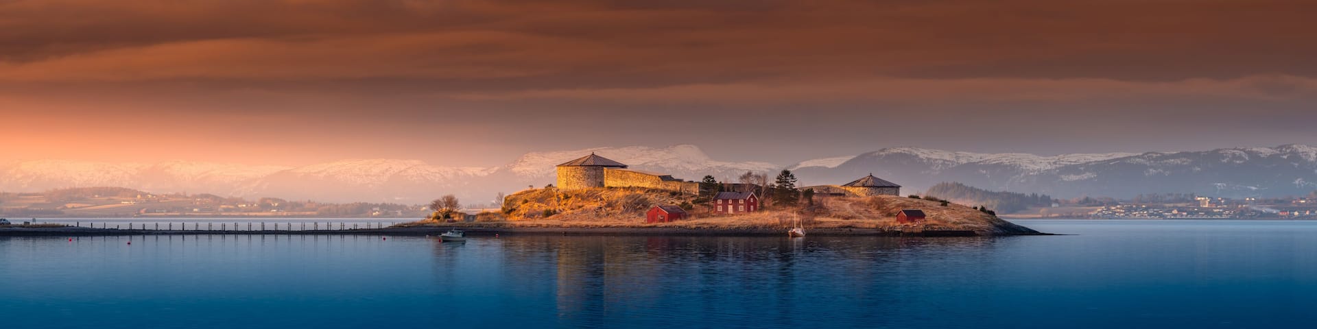 Aerial footage of Stenvikholmen monastery in winter sun. An old castle in Stjordal area in Trondelag, Norway