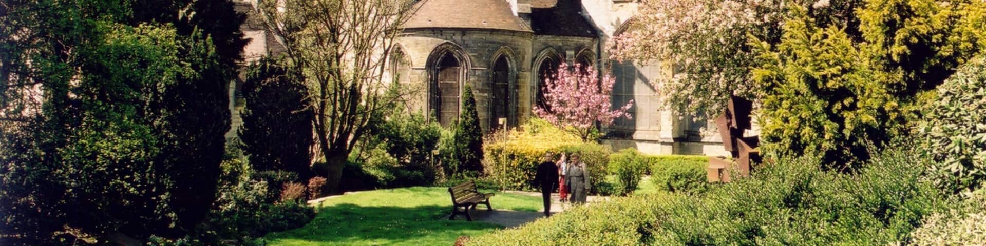 Lisieux which includes a church or cathedral, heritage architecture and flowers