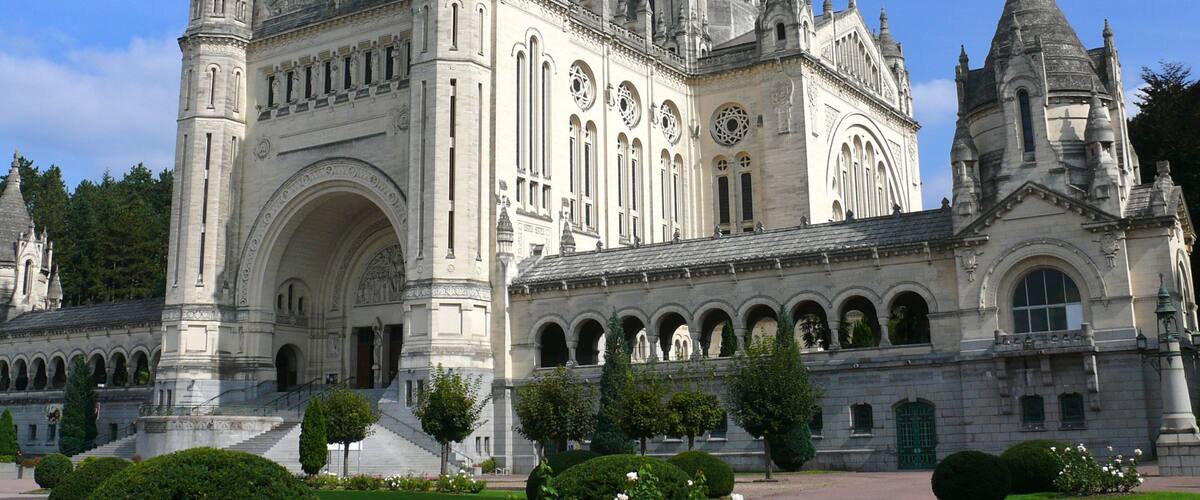 A grand, ornate cathedral with multiple spires and a large clock tower.