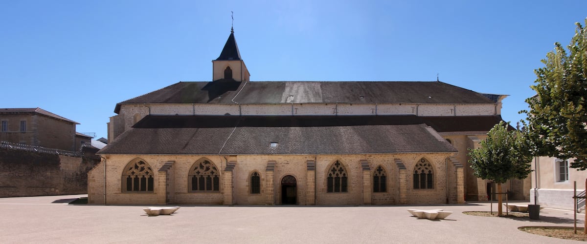 A historic church with a prominent tower and arched windows.