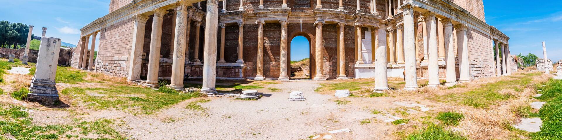 An ancient Roman amphitheater with columns and an arched entrance.
