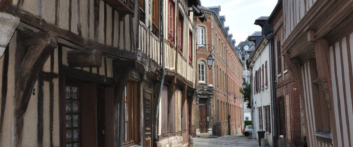 A cobblestone street lined with historic half-timbered buildings.