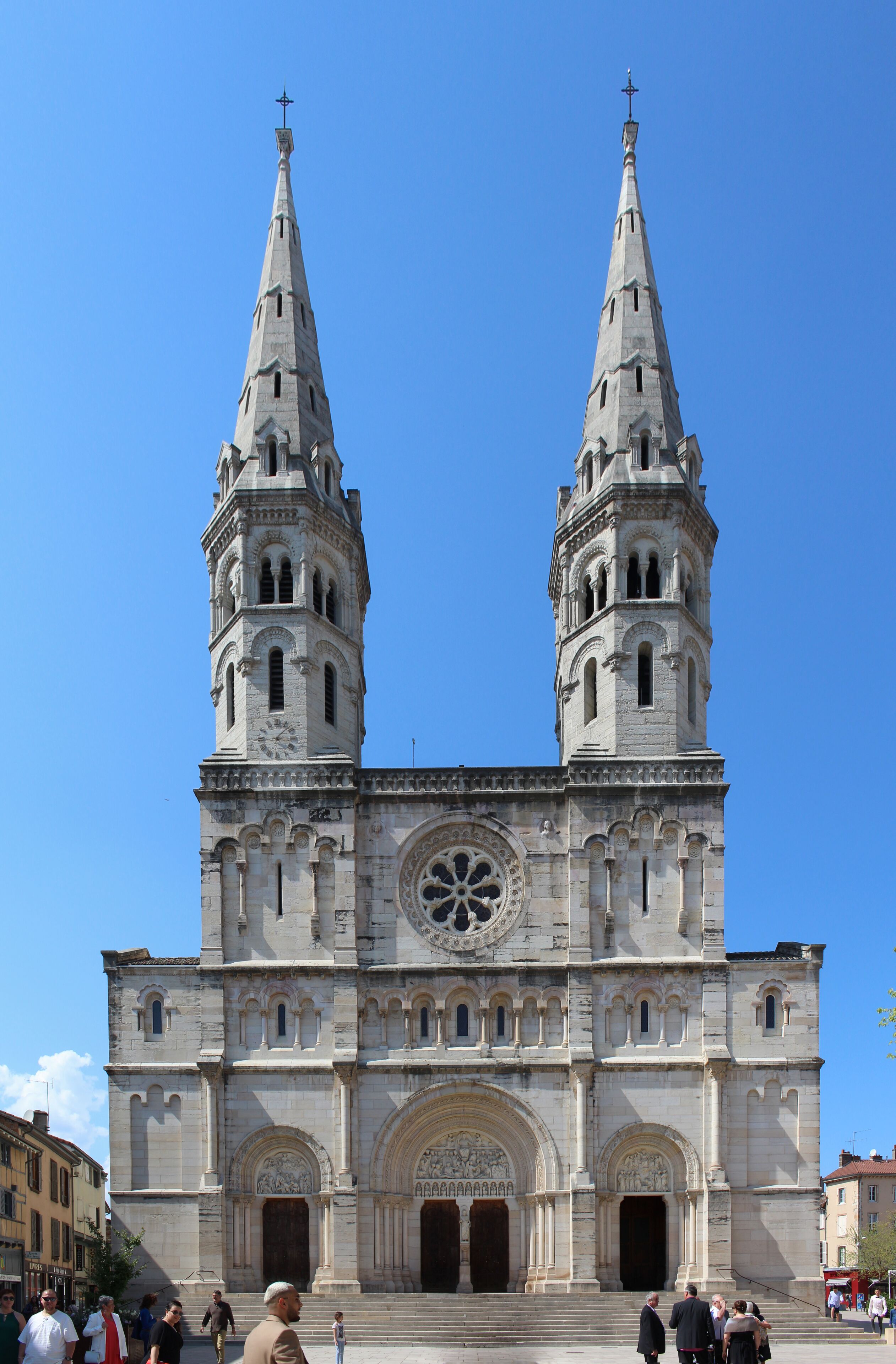 A large cathedral with two tall spires and a large circular window.