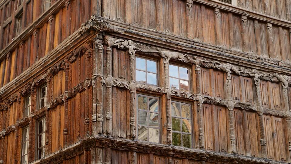 A building with ornate wooden carvings and multiple windows.