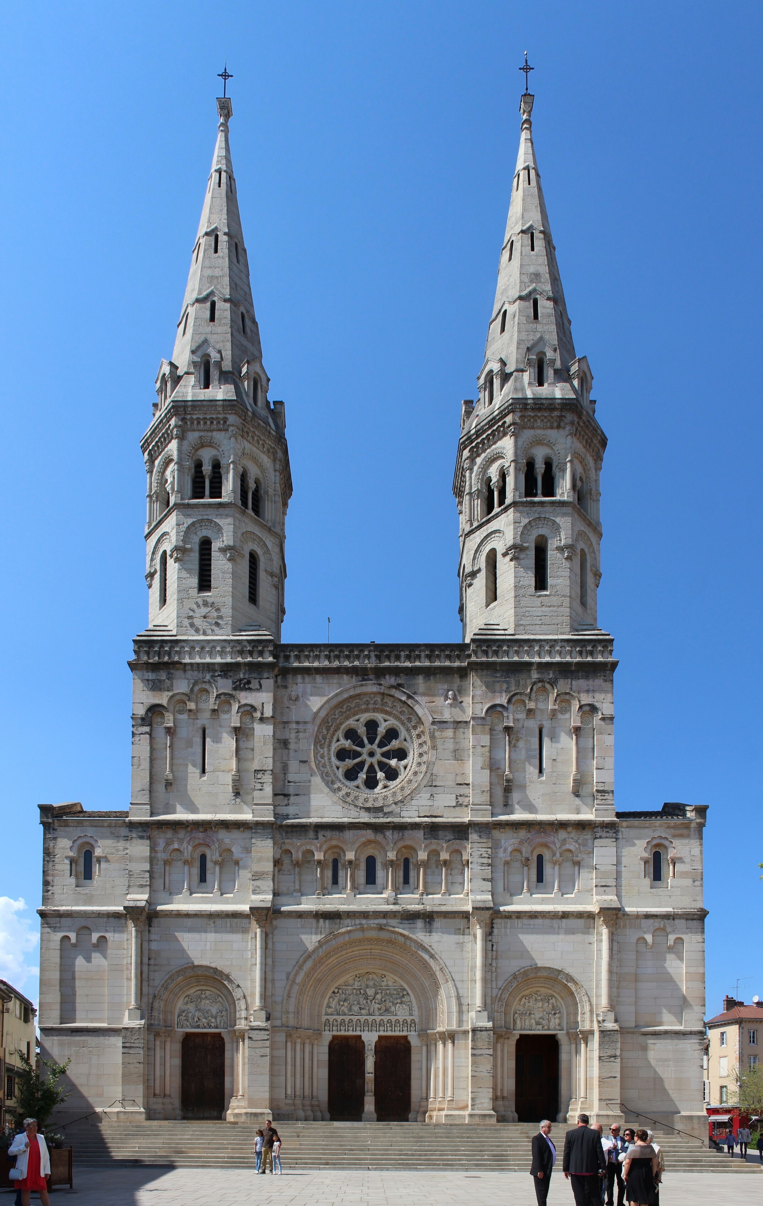 A large cathedral with two tall towers and a central rose window.