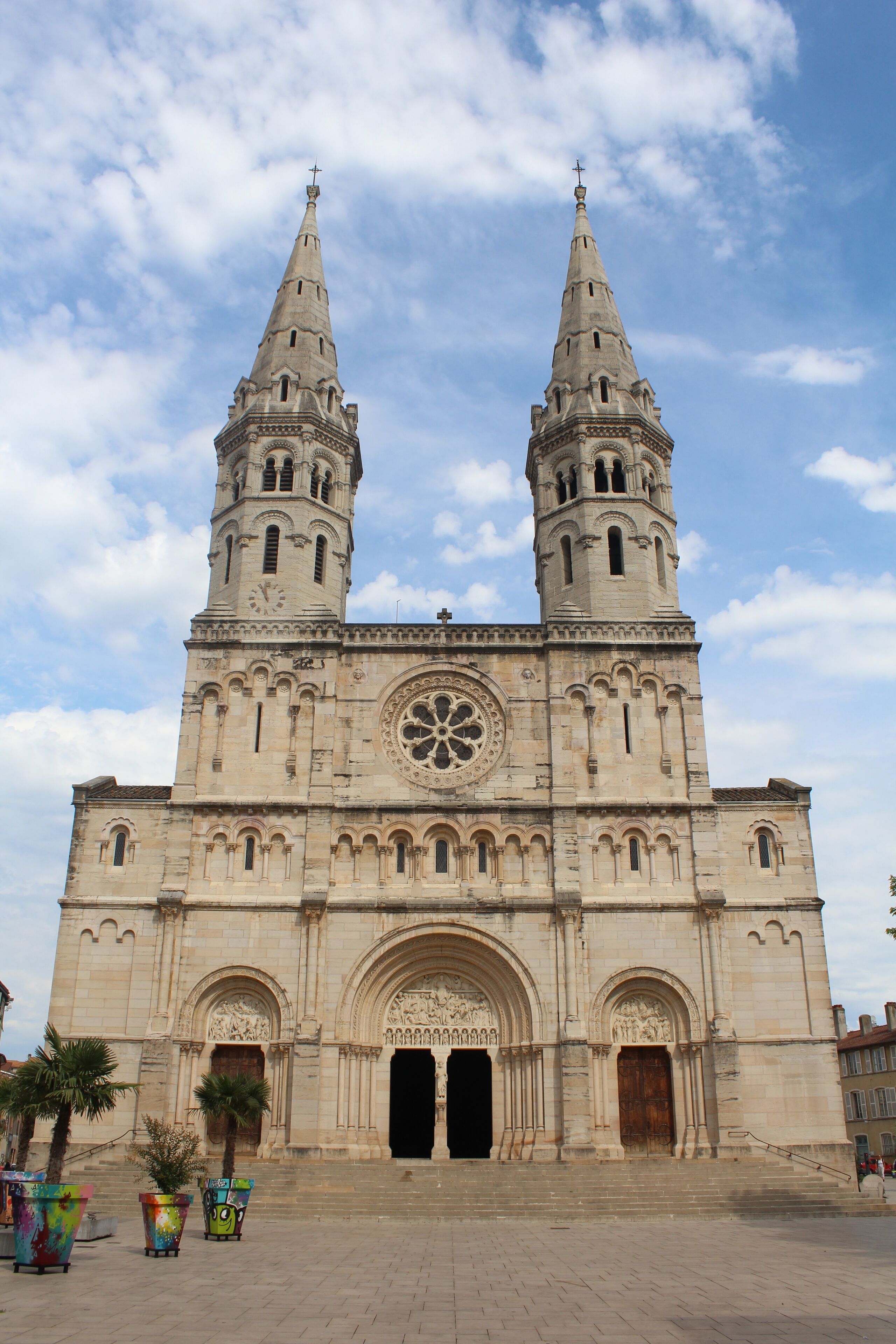 A large cathedral with two tall spires and a large circular window.