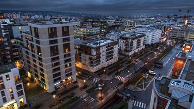 The town of Massy with its residential and industrial buildings lit up at night in the Parisian suburbs in France