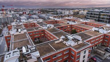 The town of Massy with its residential and industrial buildings lit up at night in the Parisian suburbs in France