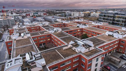 The town of Massy with its residential and industrial buildings lit up at night in the Parisian suburbs in France