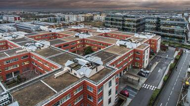 The town of Massy with its residential and industrial buildings lit up at night in the Parisian suburbs in France