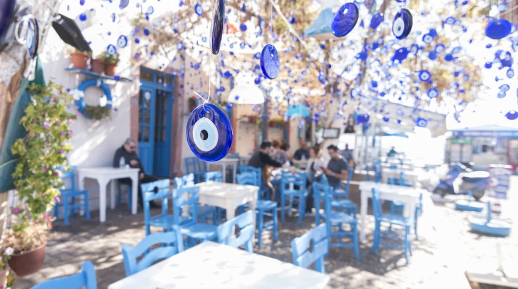 CUNDA ISLAND, AYVALIK, TURKEY - October 16, 2017: Evil eyes are hung in decorative purpose with a tree on the background in Cunda Alibey Island, Ayvalik.