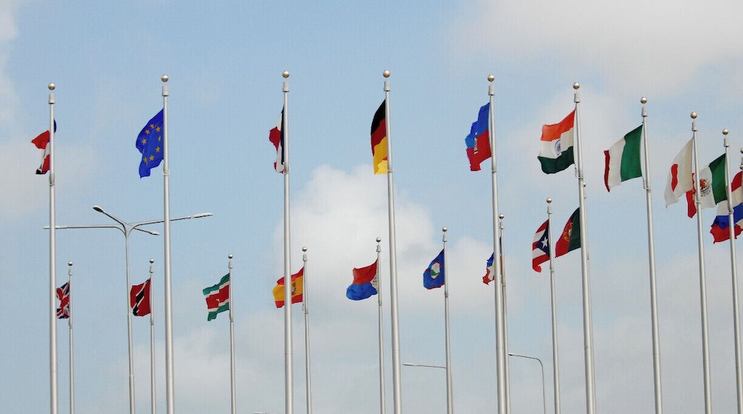 The main airport in Aruba welcomes visitors with a traffic roundabout that displays it's international collection of flags!