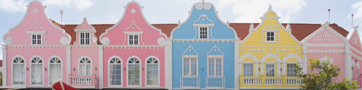 A row of colorful buildings with distinct architectural styles and pastel colors.