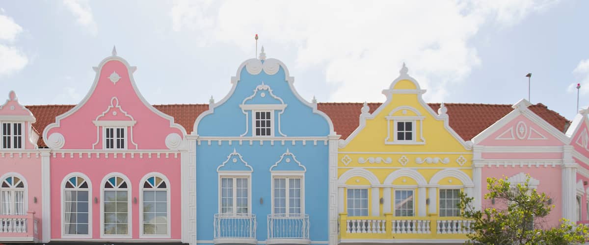 A row of colorful buildings with distinct architectural styles and pastel colors.