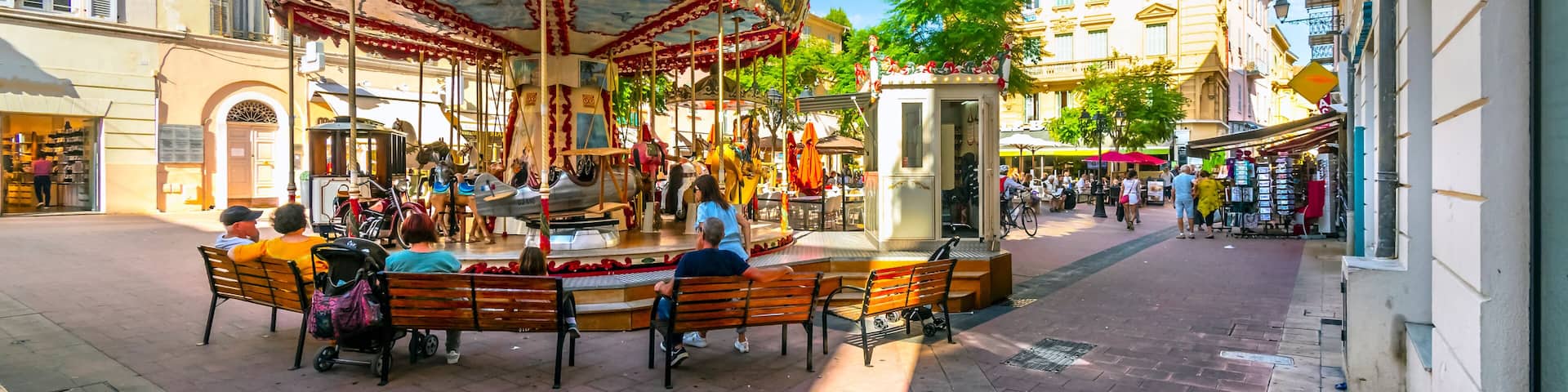 A carousel merry-go-round in a small square in the old town section of Menton, France, along the French Riviera.