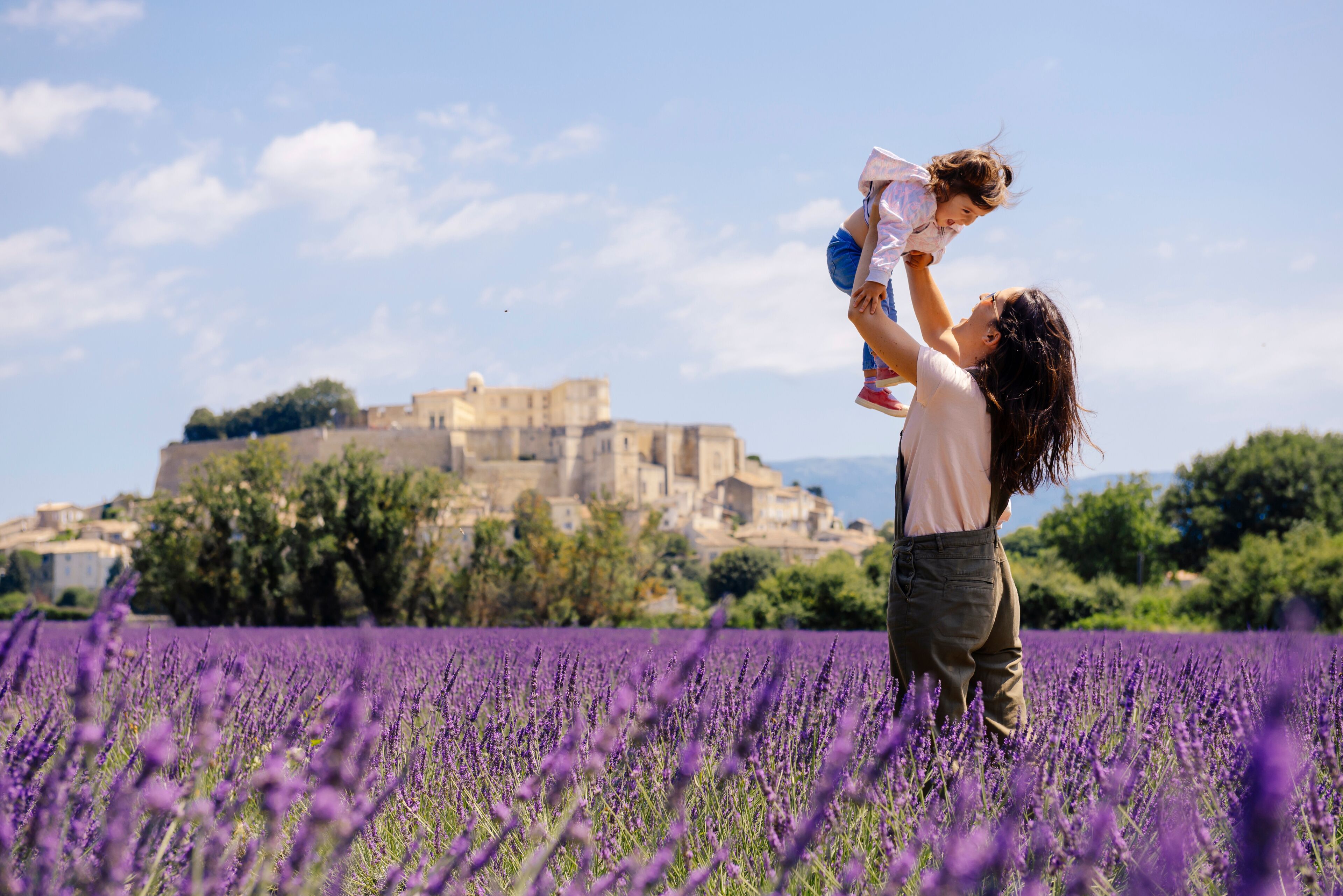 France, Grignan, mother and little daughter having fun together in lavender field