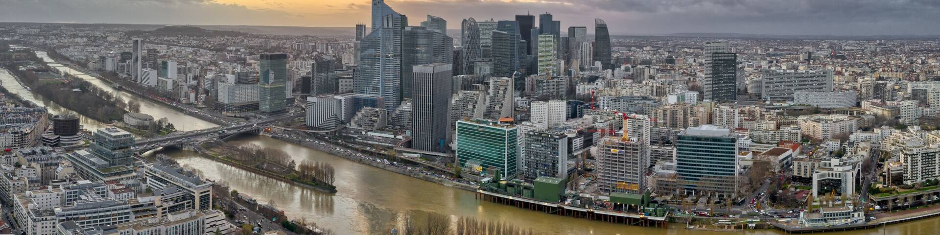 Panoramic aerial drone shot of la defense skyscraper complex in financial CBD area in Paris during sunset hours