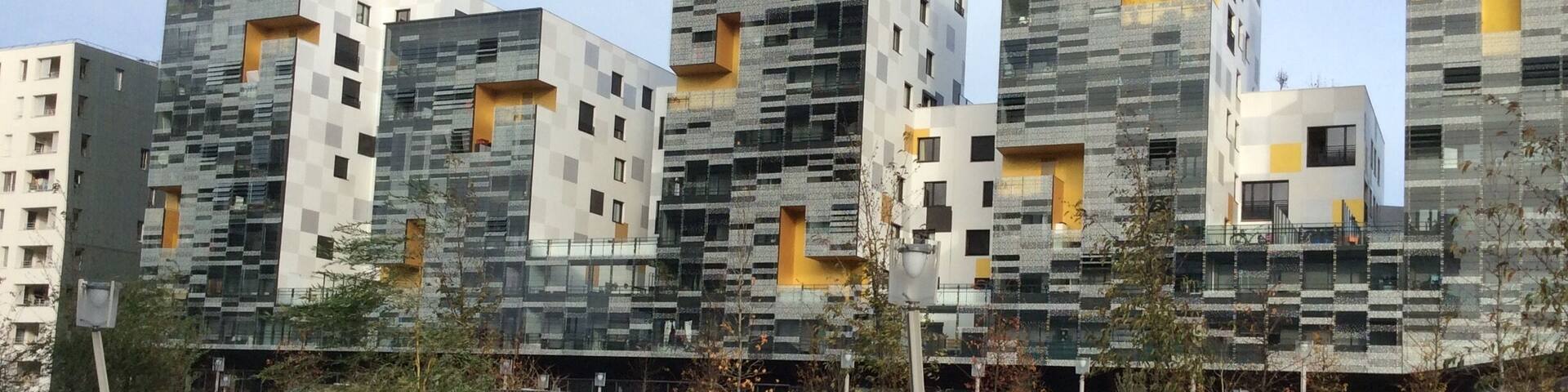 A modern residential complex with geometric patterns and balconies.