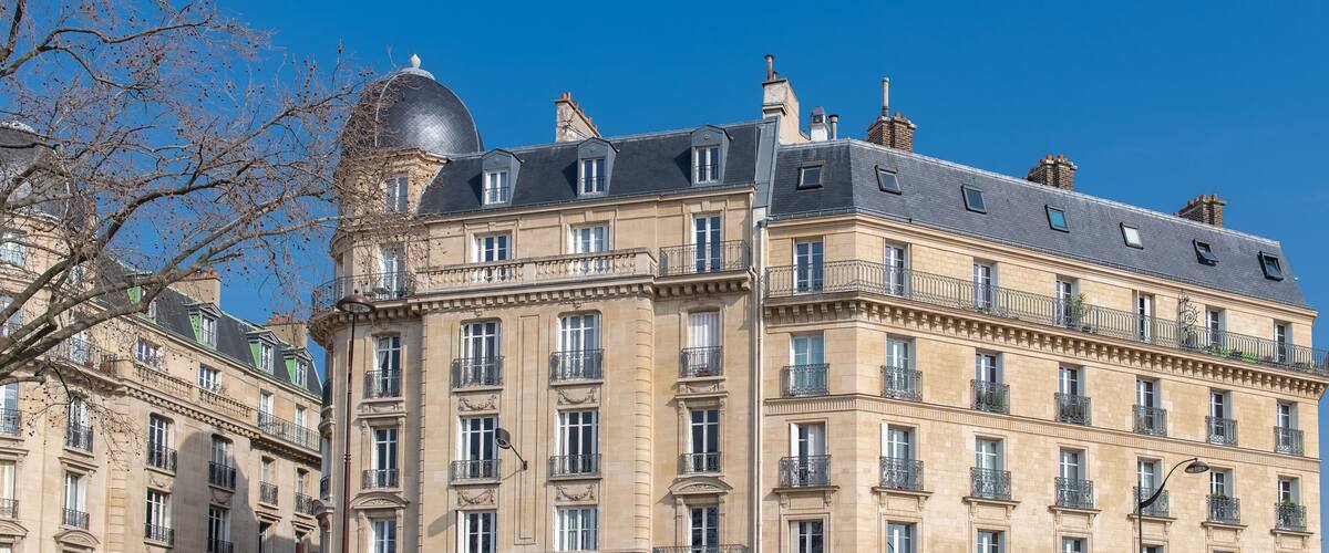 A historic building with ornate balconies and a dome.