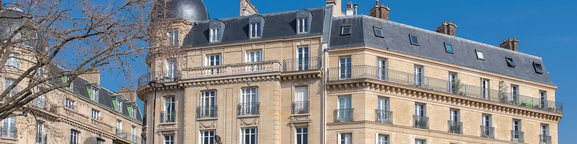 A historic building with ornate balconies and a dome.