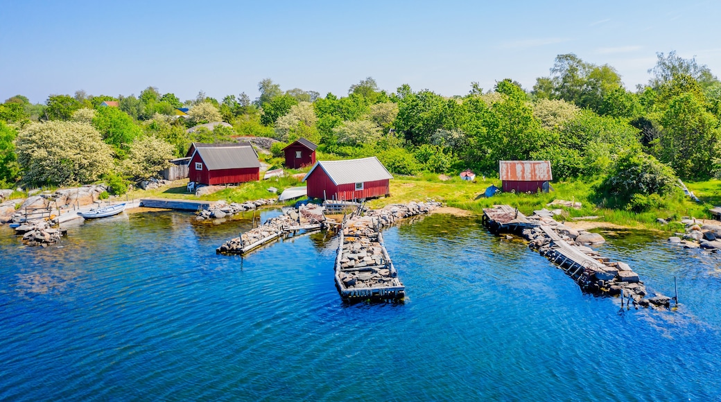 Stone filled jetties and fishing sheds seen from the sea. Location Hasslo island in Blekinge archipelago, Sweden.