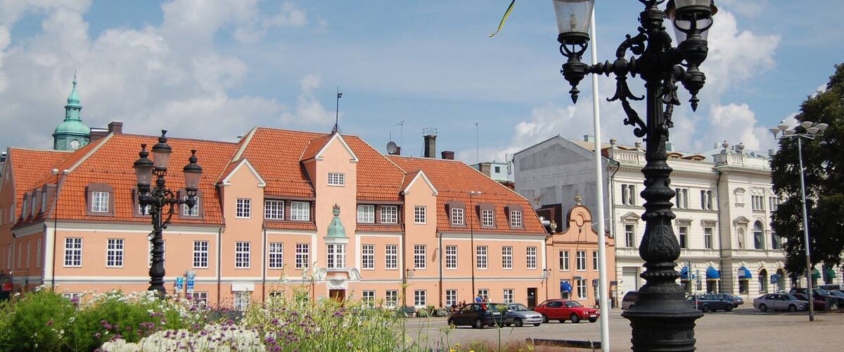 A historic building with red-tiled roofs and a clock tower.