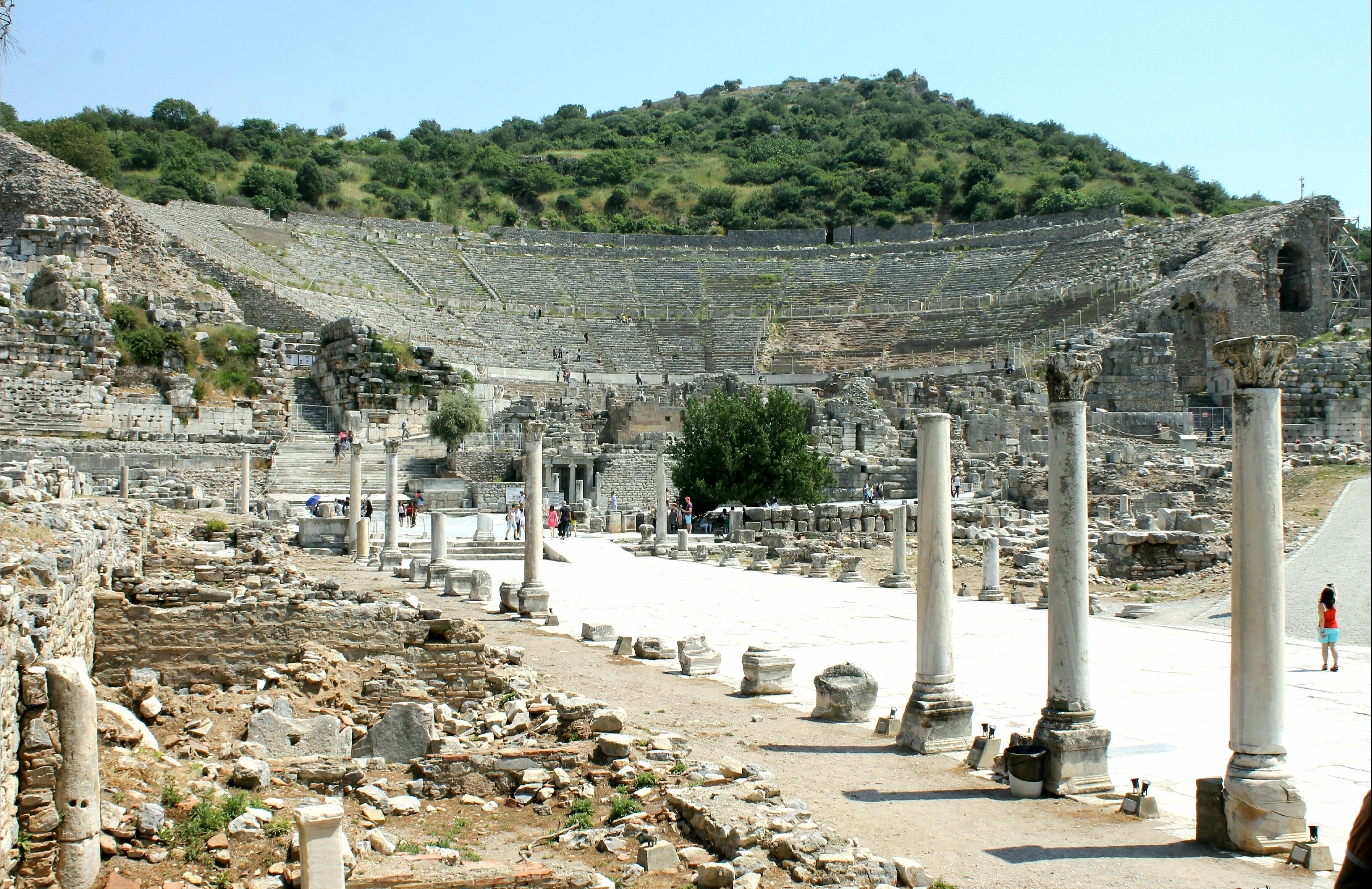 This is the most magnificent structure in Ephesus ancient city. The Great Theatre is located on the slope of Panayir Hill, opposite the Harbor Street, and easily seen when entering from the south entrance to Ephesus. It was first constructed in the Hellenistic Period, in the third century BC during the reign of Lysimachos, but then during the Roman Period, it was enlarged and formed its current style that is seen today.

It is the largest in Anatolia and has the capacity of 25,000 seats. The cavea has sixty six rows of seats, divided by two diazoma (walkway between seats) into three horizontal sections. There are three sections of seats. In the lower section, Marble pieces, used for restoration, and the Emperor's Box were found. The seats with backs ,made of marble, were reserved for important people. The audience entered from the upper cavea.

The stage building is three-storied and 18 meters high. The facade facing the audience was ornamented with relieves, columns with niches, windows and statues. There are five doors opening to the orchestra area, the middle one of which is wider than the rest. This enhanced the appearance of the stage, giving it a bigger, monumental look.

The theatre was used not only for concerts and plays, but also for religious, political and philosophical discussions and for gladiator and animal fights.

Best time to visit this magnificient archeological site is between march and may. Summer months are always with temperatures above 45°C.
#History Photo Contest
#Ancient
#InStone
#Turkey
#Lifeatexpedia