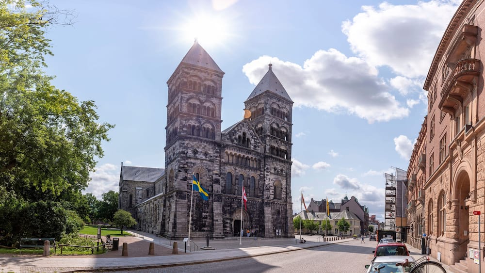 Lund, Sweden - July 2021: Lund Cathedral and bell tower building in central Lund on a summer day, Sweden, south of Lund Cathedral in Skane.