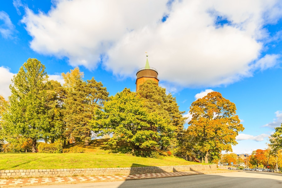Gamla Vattentornet, Skolgatan 13, Säffle, Sweden, October 5, 2019: 45 meter high water tower of Säffle designed by architect Ivar Justus Tengbom surrounded with trees in autumn colors