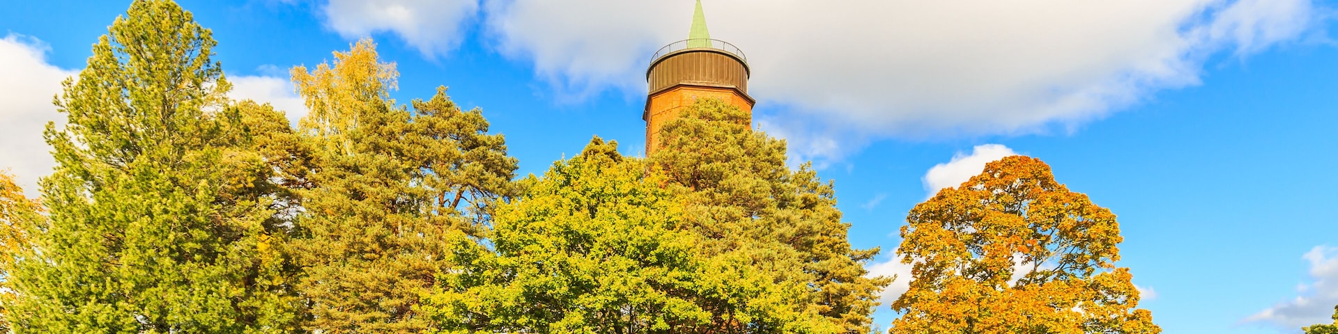 Gamla Vattentornet, Skolgatan 13, Säffle, Sweden, October 5, 2019: 45 meter high water tower of Säffle designed by architect Ivar Justus Tengbom surrounded with trees in autumn colors