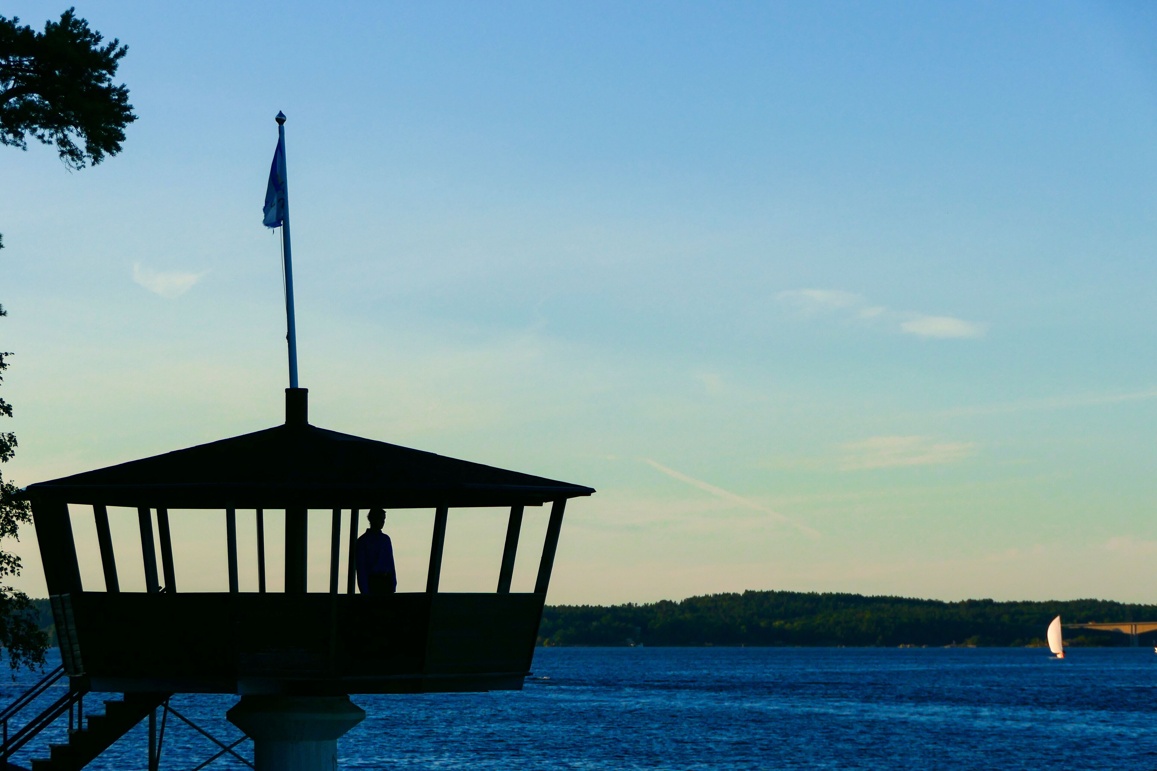 Stockholm, Sweden  A man stands in a small lookout platform in the suburb of Saltsjobaden looking out over the bay.