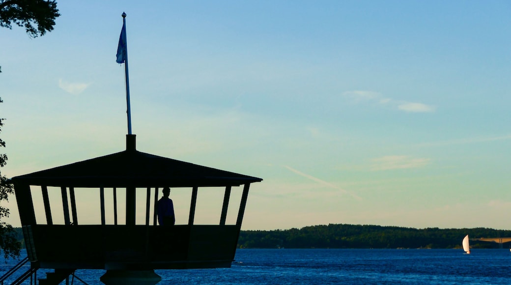 Stockholm, Sweden A man stands in a small lookout platform in the suburb of Saltsjobaden looking out over the bay.