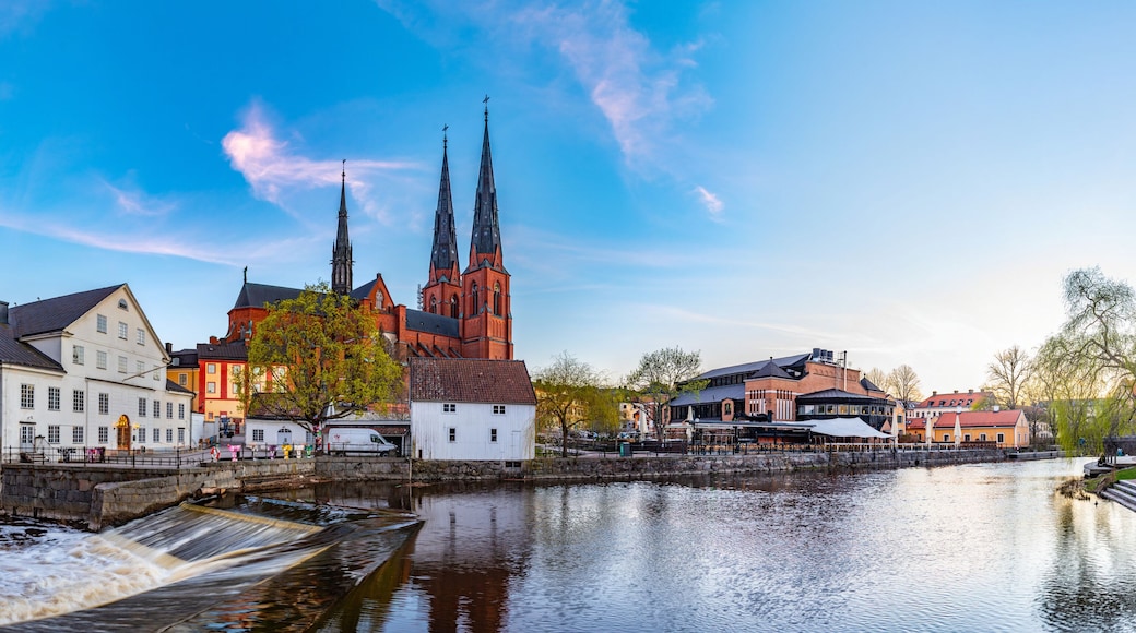 Sunset view of white building of Uppland museum and cathedral in Uppsala, Sweden